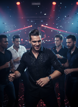 Man in a black shirt with sequins dancing in front of a group of people with red and blue lights in the background